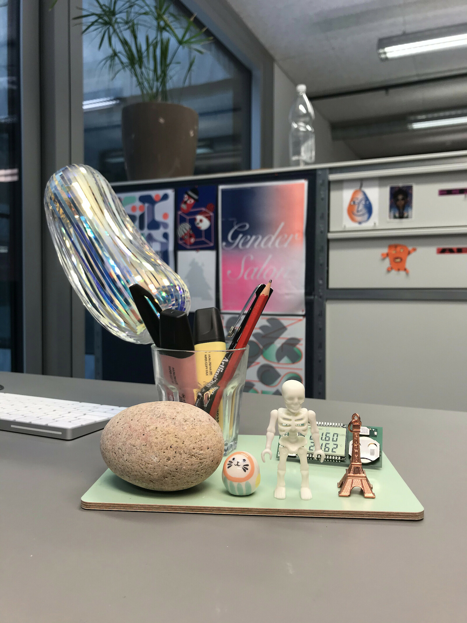 On my work table: round stone from the island of Mön (found by myself), a small ceramic figurine (gift from a friend), a Playmobil skeleton (gift from my son), an Eifel Tower pendant (souvenir from Paris) and a rainbow foil object (gift from Japan from an alumnus).